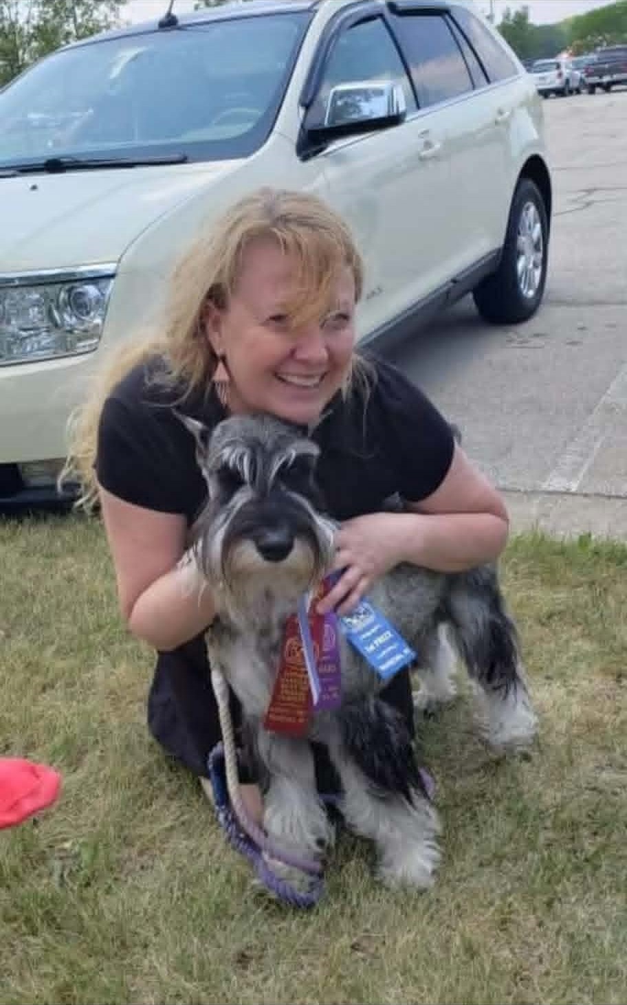 Amy embracing Ms. Myrtle with her show ribbons